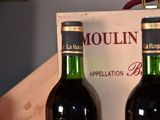 two bottles of wine sitting next to each other on a table