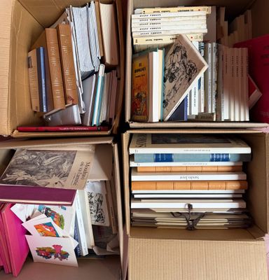 boxes of books are stacked on top of each other in a room