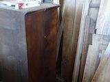 several pieces of wood sit in a room with a clock on the wall