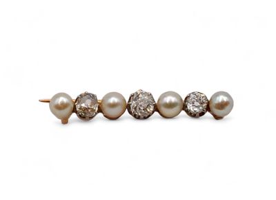 a pair of pearl and diamond earrings on a white background