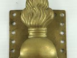 an image of a brass door handle with a flower on it