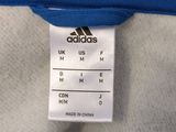 a close up of a blue shirt with a tag on it