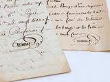 two old papers with writing on them sitting next to each other