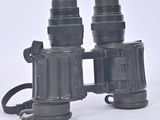 an image of a pair of binoculars sitting on top of a white surface