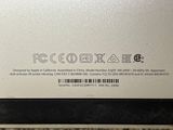 the back of a laptop computer with a sticker on it ' s side