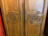 two wooden doors with carvings on them in a room
