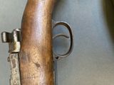 a gun that is sitting on a table next to a clock