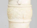 a close up of a white vase with a spiral design on it