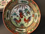 a bowl with a rooster design on it and a bowl with a rooster design on it
