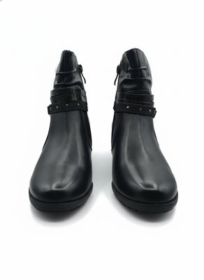 pair of black leather ankle boots with buckles on a white surface