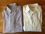 two men ' s shirts sitting on a wooden table next to each other