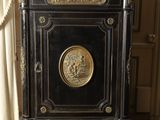a black cabinet with a horse and carriage on top of it