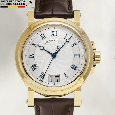 a gold wrist watch with roman numerals on the face