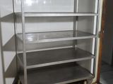 a metal shelf in the corner of a room