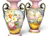 two vases that are painted with flowers on them