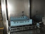 a dishwasher in the middle of a stainless steel oven