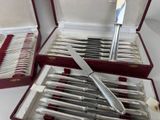 a lot of silverware in a box with a knife in it