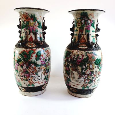 two vases sitting side by side on a white surface