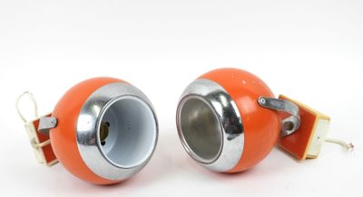 two orange speakers sitting on a white surface