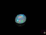an image of a white fire opal in the dark