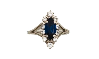 un gros plan sur une bague sertie d'un saphir bleu et de diamants