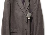 the suit jacket is hanging on a hanger on a white wall