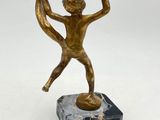 bronze figurine of a boy on a marble base