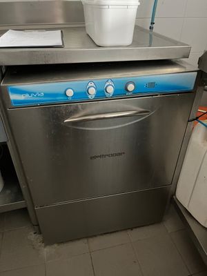 stainless steel dishwasher with a bucket on top of it in a kitchen
