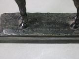 a bronze statue of a man riding a horse