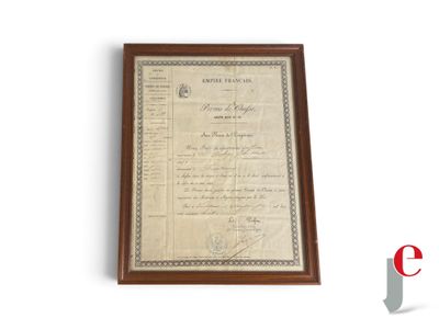 an old document is hanging on a wall next to a plaque