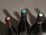 four bottles of wine are lined up on a table