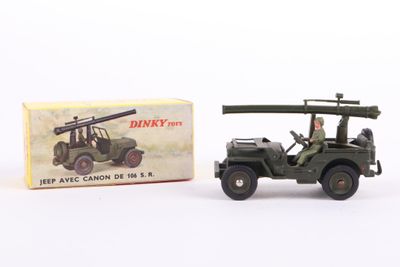 an old toy army jeep with a gun on top of it