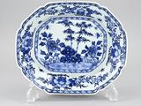 a blue and white plate with a landscape scene on it
