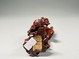 a close up of a small figurine of a man on a motorcycle