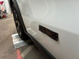 a close up of a white car with a sticker on it