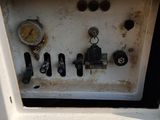 a white machine that has a bunch of gauges on it