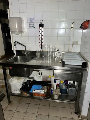 a kitchen with a sink and a counter with dishes on it
