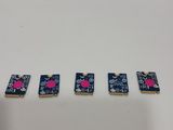 a close up of four small pieces of electronics on a white surface