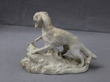 a statue of a dog and a cat on a rock