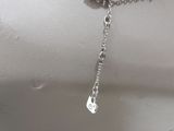 silver plated necklace with a heart charm on a mannequin head