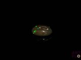 a picture of a black background with a green light in the middle