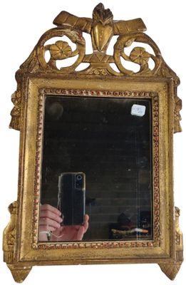 a person taking a picture of a mirror with a cell phone