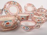 many different types of tea cups and saucers on the table