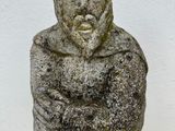 a stone statue of a man with a beard