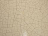 a close up of a white bowl with a cracky surface