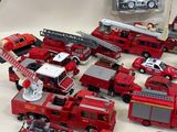 a lot of toy firetrucks that are sitting on a table