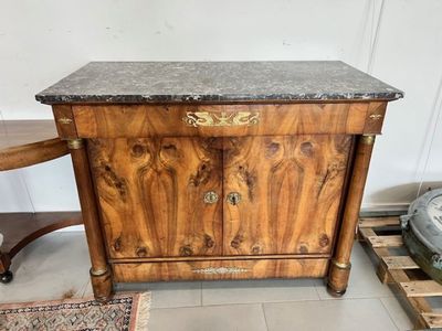 a wooden cabinet with a marble top in a room