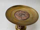 a gold plate with a flower design on it
