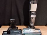 a vacuum that is sitting on a table next to a pair of scissors