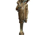 a bronze statue of a woman holding a vase on a stand